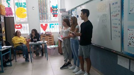 Image may contain: 3 people, people sitting and people standing